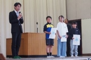 遊・友スポーツランキングちば年間大賞授与式で児童がお祝いの言葉をかけられている写真
